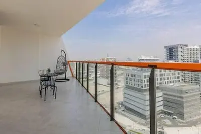 a balcony with a table and chairs on a building at Contemporary 2 Bedroom Apartment in Dubai