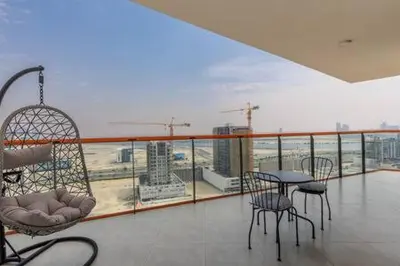 a balcony with a table and chairs and a view at Contemporary 2 Bedroom Apartment in Dubai