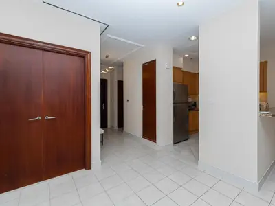 a hallway with a wooden door and a kitchen at Exclusive 2BR in Al Yass Tower Dubai Marina - Private Terrace & Premium Community, Managed by Think Realty in Dubai