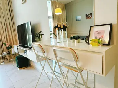 a kitchen with a desk with two chairs and a television at Luxury Oasis - Burj Khalifa Views in Dubai