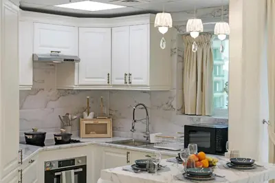 a kitchen with white cabinets and a sink with fruits on the counter at High Floor Upgraded 2BR in JLT - Walk to Lake Park in Dubai