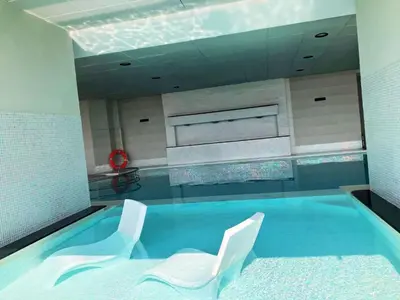 a swimming pool with two white chairs in it at High Floor Upgraded 2BR in JLT - Walk to Lake Park in Dubai