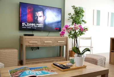 a living room with a flat screen tv on a wall at Upgraded & Cozy Boutique Studio in Palm Jumeirah PV7 in Dubai