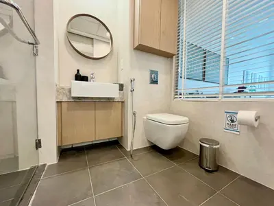 a bathroom with a toilet and a sink and a mirror at Upgraded & Cozy Boutique Studio in Palm Jumeirah PV7 in Dubai