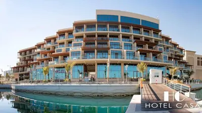 a hotel with a large building next to a body of water at Upgraded & Cozy Boutique Studio in Palm Jumeirah PV7 in Dubai