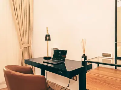 a black desk with a laptop on it in a room at New Fairmont Residence Private Beach club access Palm Jumeirah in Dubai