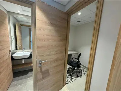a bathroom with a wooden door and a sink at 1 bedroom apartment in Jumeirah in Dubai