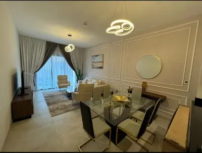 a living room with a glass table and chairs at 1 bedroom apartment in Jumeirah in Dubai