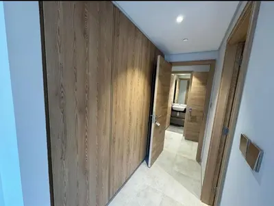 a hallway with wooden walls and a door in a room at 1 bedroom apartment in Jumeirah in Dubai