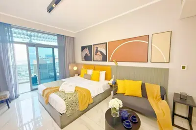 a bedroom with a large bed and a couch at Top Floor Studio with Sofa Bed Walk to Dubai Mall by Vibel in Dubai