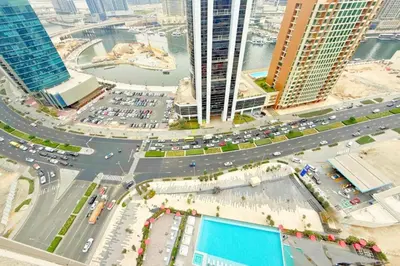 an aerial view of a city with traffic and buildings at Top Floor Studio with Sofa Bed Walk to Dubai Mall by Vibel in Dubai