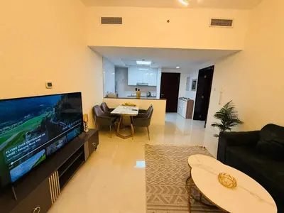 a living room with a large flat screen tv at 1BHK LUXURY PRIVATE APARTMENT - Dubai Marina - 2 MIN WALK FROM TRAM in Dubai