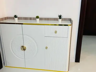 a white cabinet with plants on top of it at 1BHK LUXURY PRIVATE APARTMENT - Dubai Marina - 2 MIN WALK FROM TRAM in Dubai