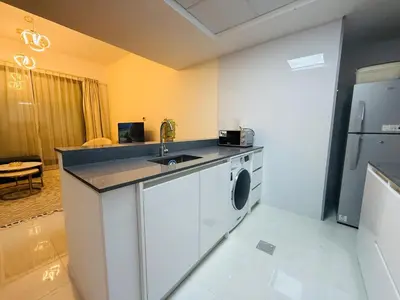 a kitchen with a sink and a washing machine at 1BHK LUXURY PRIVATE APARTMENT - Dubai Marina - 2 MIN WALK FROM TRAM in Dubai