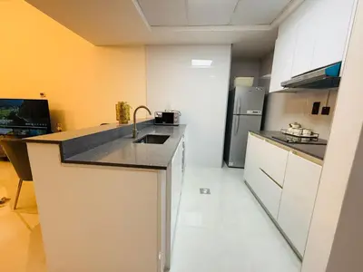 a kitchen with a sink and a refrigerator at 1BHK LUXURY PRIVATE APARTMENT - Dubai Marina - 2 MIN WALK FROM TRAM in Dubai