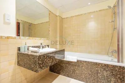 a bathroom with a sink and a bath tub at Sea-Facing 1BR with Ain Dubai View Close to Marina Beach, Rimal 3, Jumeirah Beach Residence by Deluxe Holiday Homes in Dubai