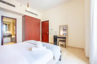 a bedroom with a white bed and a bathroom at Sea-Facing 1BR with Ain Dubai View Close to Marina Beach, Rimal 3, Jumeirah Beach Residence by Deluxe Holiday Homes in Dubai