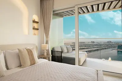 a bedroom with two beds and a large window at Luxe 4BR with Panoramic Views l Marina & Burj in Dubai