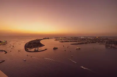 an aerial view of a beach with boats in the water at Luxe 4BR with Panoramic Views l Marina & Burj in Dubai