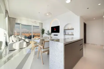 a kitchen and living room with a view of the city at Luxe 4BR with Panoramic Views l Marina & Burj in Dubai