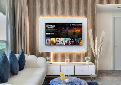a living room with a couch and a tv at Nice 2 Bedroom Apartment! 5 Minute walk to Dubai Mall! Burj Khalifa View! in Dubai