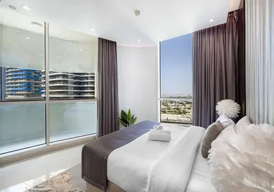 a bedroom with a large bed and a large window at Nice 2 Bedroom Apartment! 5 Minute walk to Dubai Mall! Burj Khalifa View! in Dubai