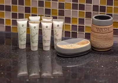 a group of four toiletries sitting on a counter at Nice 2 Bedroom Apartment! 5 Minute walk to Dubai Mall! Burj Khalifa View! in Dubai