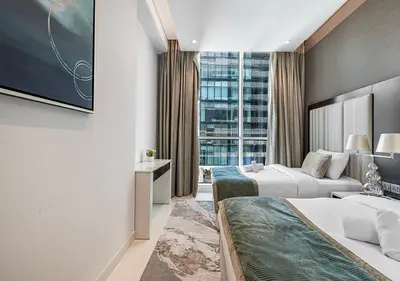 a hotel room with two beds and a window at Nice 2 Bedroom Apartment! 5 Minute walk to Dubai Mall! Burj Khalifa View! in Dubai