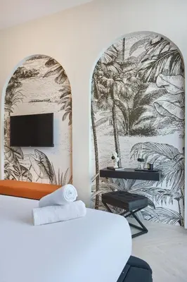 a bedroom with a bed and a tv on a wall at Stylish Studio Retreat Modern Stay in JVC in Dubai