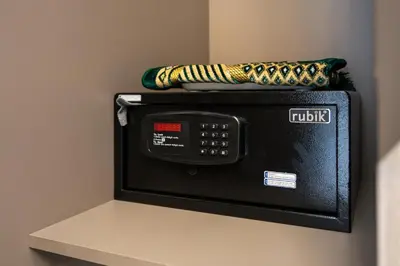 a black microwave with a towel on top of it at Modern Meydan Studio Burj View Downtown in Dubai