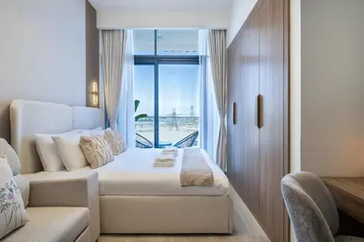 a hotel room with a bed and a window at Modern Meydan Studio Burj View Downtown in Dubai