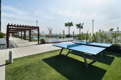 two ping pong tables on the roof of a building at Modern Meydan Studio Burj View Downtown in Dubai