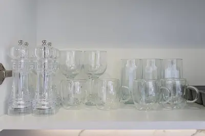 a row of clear glasses sitting on a shelf at Luxury Meydan Studio Near Dubai Mall & Downtown in Dubai