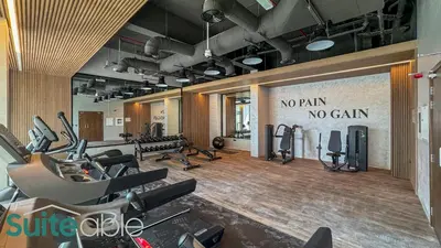 a gym with several treadmills and machines in it at Luxe Interior Studio in Pantheon Elysee 3 in JVC in Dubai
