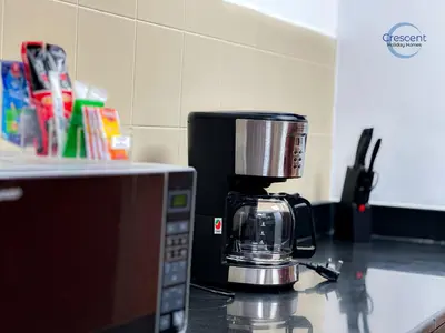 a coffee maker sitting on top of a microwave at Relaxing Beach Escape in JBR in Dubai