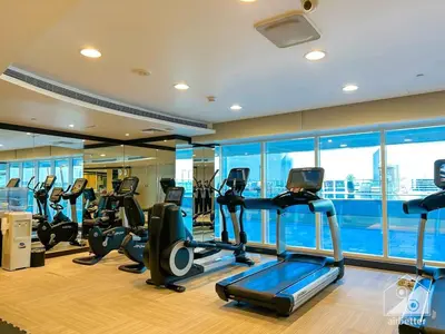 a gym with treadmills and ellipticals in a building at Luxury Studio in Business Bay with Canal View in Dubai