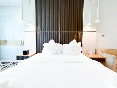 a bedroom with a large white bed with white pillows at Luxury Studio in Business Bay with Canal View in Dubai