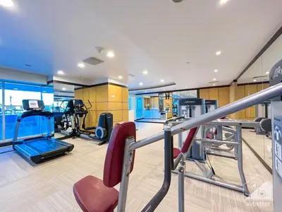 a gym with treadmills and cardio equipment in a building at Luxury Studio in Business Bay with Canal View in Dubai
