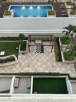 an overhead view of a patio with a pool at Studios Apartment in Azizi Riviera in Dubai