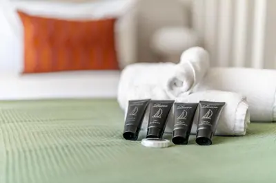 a group of four black batteries next to towels at Exquisitely designed studio in Oxford terraces JVC in Dubai