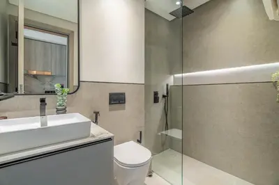 a bathroom with a sink and a toilet and a shower at Exquisitely designed studio in Oxford terraces JVC in Dubai