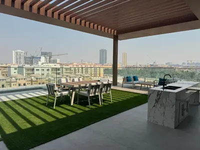 a patio with a table and chairs on a roof at Exquisitely designed studio in Oxford terraces JVC in Dubai