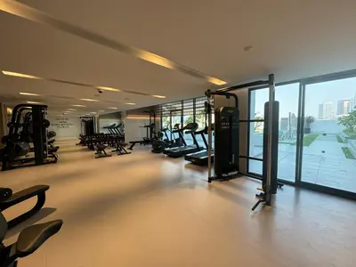 a gym with treadmills and machines in a building at Exquisitely designed studio in Oxford terraces JVC in Dubai