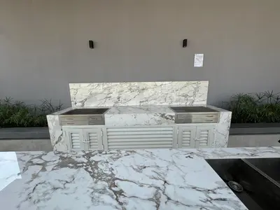 a marble counter with two drawers and a fireplace at Exquisitely designed studio in Oxford terraces JVC in Dubai