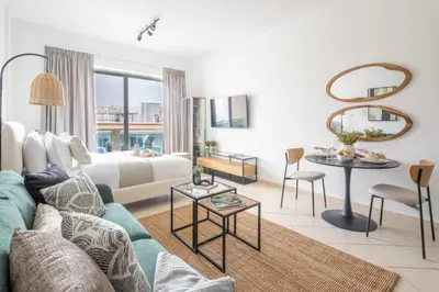 a living room with a couch and a table at Frank Porter - Lago Vista in Dubai