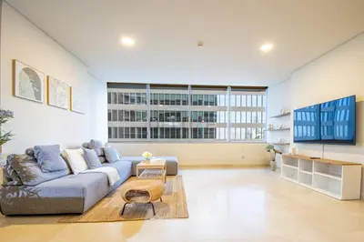 a living room with a couch and a large window at City-Centered 1BR, Minutes to Metro and Key Attractions, Sky Gardens, DIFC by Deluxe Holiday Homes in Dubai