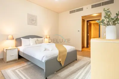a bedroom with a king sized bed in a room at City-Centered 1BR, Minutes to Metro and Key Attractions, Sky Gardens, DIFC by Deluxe Holiday Homes in Dubai