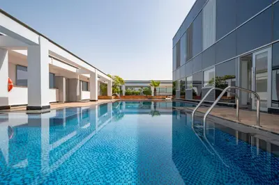 a swimming pool in front of a building at City-Centered 1BR, Minutes to Metro and Key Attractions, Sky Gardens, DIFC by Deluxe Holiday Homes in Dubai