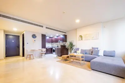 a large living room with a couch and a table at City-Centered 1BR, Minutes to Metro and Key Attractions, Sky Gardens, DIFC by Deluxe Holiday Homes in Dubai