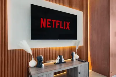 a tv on a wall with a netflix sign on it at Stylish JLT Studio Lakeview Metro 5min & Marin in Dubai